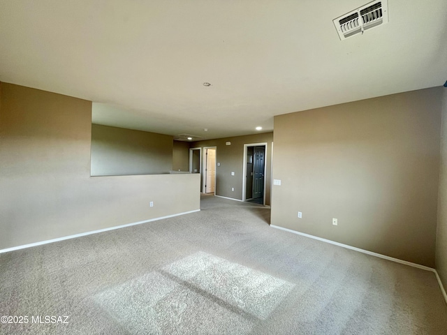 carpeted spare room featuring baseboards, recessed lighting, and visible vents