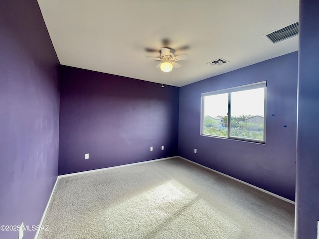 spare room with baseboards, ceiling fan, visible vents, and carpet floors