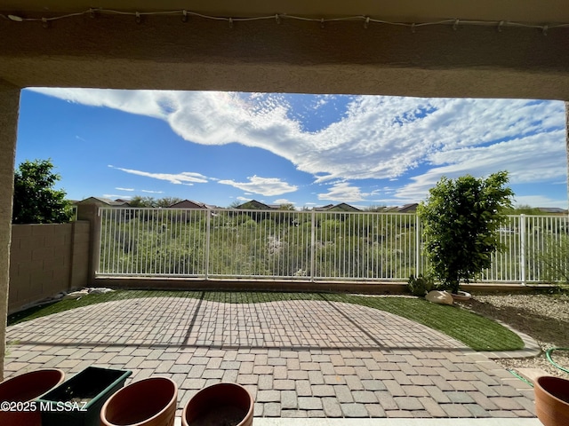 view of gate featuring fence and a patio