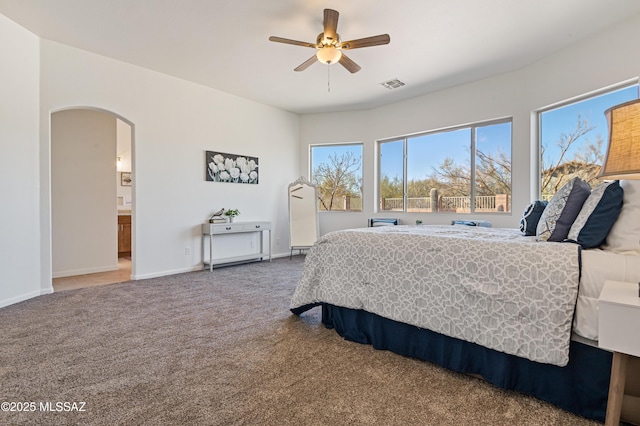 9896 E Wind Dancer Dr, Tucson, AZ 85748 - bedroom featuring ceiling fan, visible vents, arched walkways, baseboards, and carpet