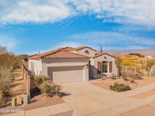 9896 E Wind Dancer Dr, Tucson, AZ 85748 - mediterranean / spanish-style home featuring fence, an attached garage, stucco siding, a tiled roof, and driveway