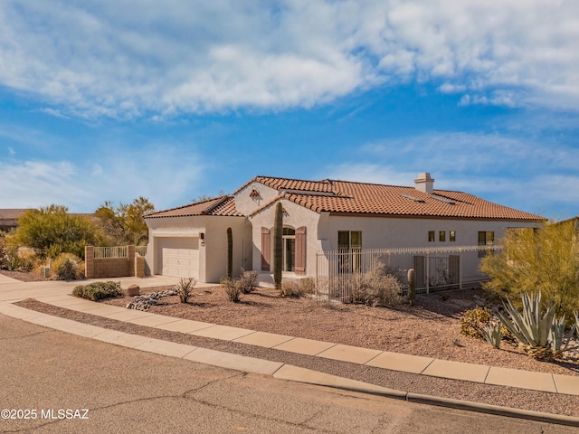 9896 E Wind Dancer Dr, Tucson, AZ 85748 - mediterranean / spanish home with a tiled roof, a chimney, a fenced front yard, and stucco siding