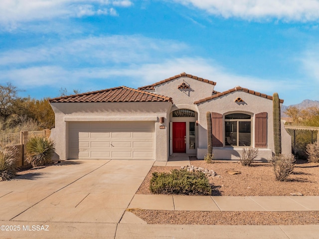 9896 E Wind Dancer Dr, Tucson, AZ 85748 - mediterranean / spanish-style house with fence, an attached garage, a tile roof, stucco siding, and driveway