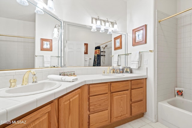 bathroom featuring double vanity, a sink, tile patterned flooring, and shower / bath combo
