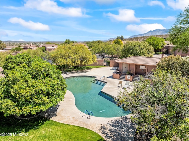 community pool featuring a patio and a mountain view