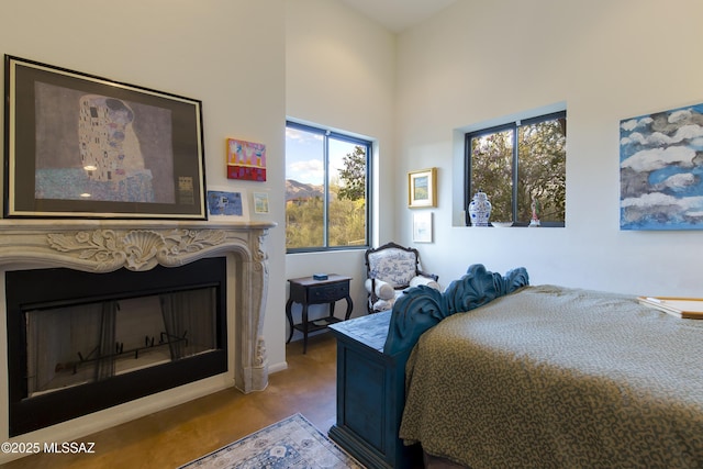 4519 N Camino Kino, Tucson, AZ 85718 - bedroom with multiple windows, a high ceiling, and a fireplace
