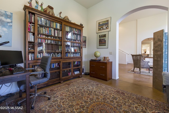4519 N Camino Kino, Tucson, AZ 85718 - home office featuring arched walkways, baseboards, and concrete flooring