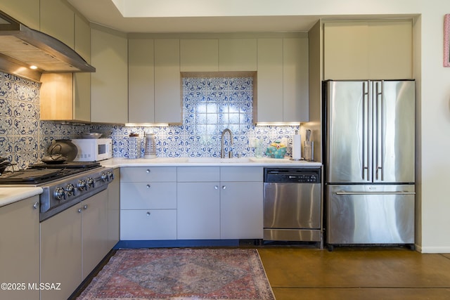 4519 N Camino Kino, Tucson, AZ 85718 - kitchen featuring stainless steel appliances, a sink, under cabinet range hood, light countertops, and tasteful backsplash