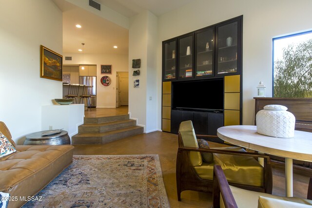 4519 N Camino Kino, Tucson, AZ 85718 - living room featuring concrete flooring, baseboards, and recessed lighting
