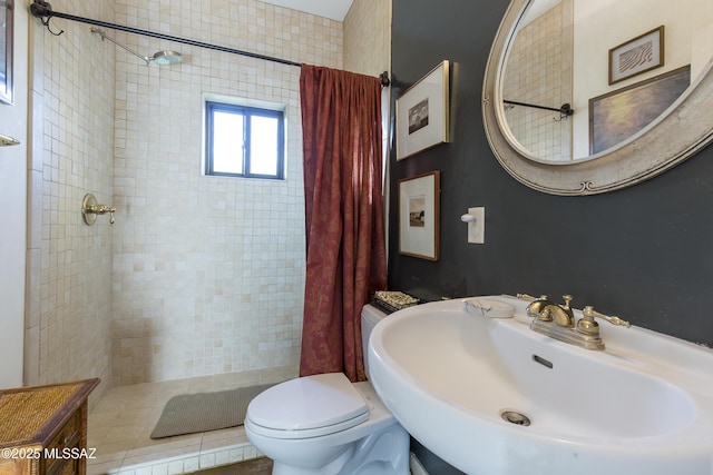 4519 N Camino Kino, Tucson, AZ 85718 - bathroom featuring a sink, a tile shower, and toilet