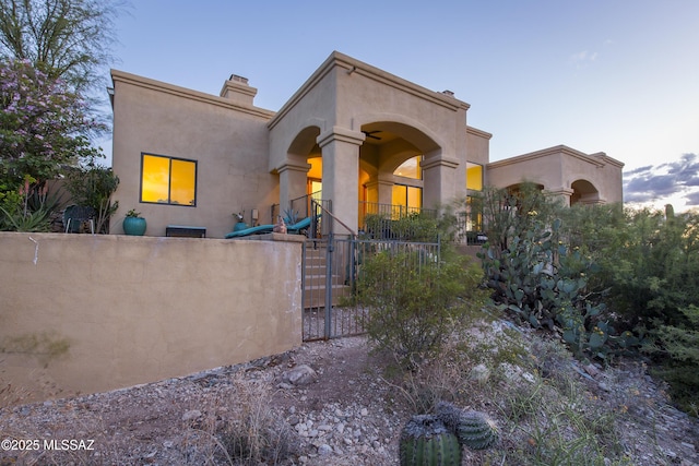 4519 N Camino Kino, Tucson, AZ 85718 - view of front of home with fence, a chimney, stucco siding, and a gate