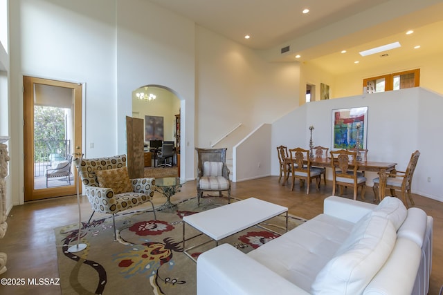 4519 N Camino Kino, Tucson, AZ 85718 - living area with a towering ceiling, arched walkways, recessed lighting, stairway, and baseboards