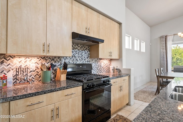 kitchen featuring light brown cabinetry, black gas range oven, and under cabinet range hood