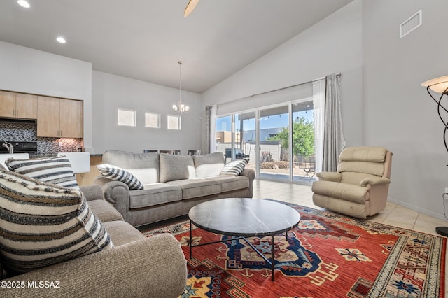 living room featuring visible vents, light tile patterned floors, high vaulted ceiling, a chandelier, and recessed lighting