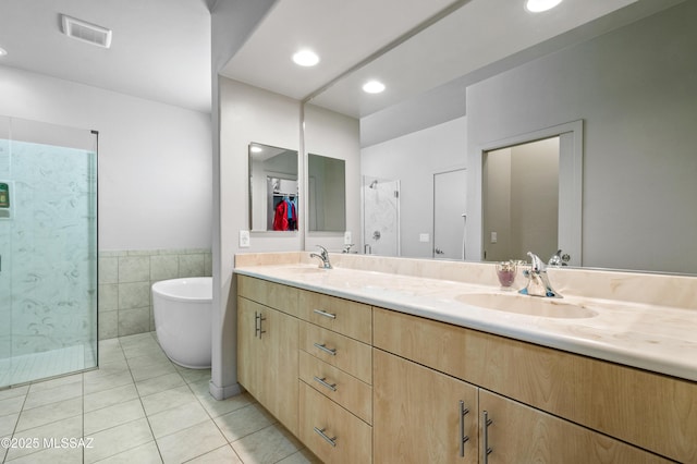 full bath featuring tile patterned floors, visible vents, a sink, and a stall shower