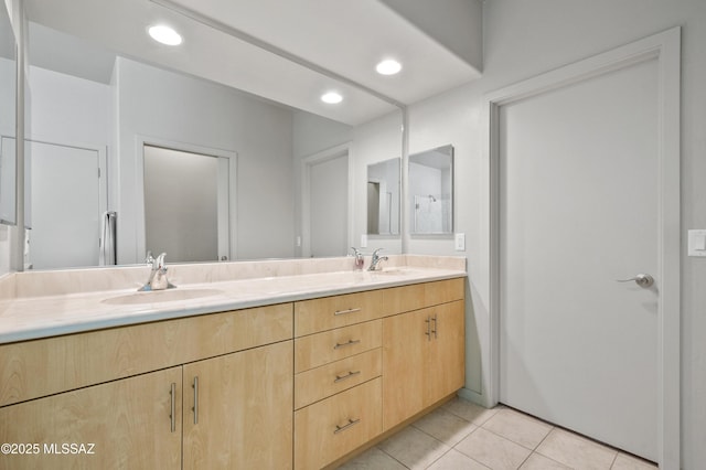 full bathroom with a sink, tile patterned floors, recessed lighting, and double vanity