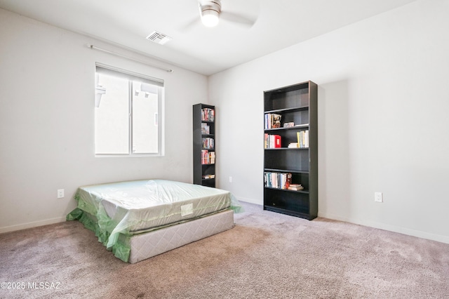 bedroom with carpet floors, baseboards, visible vents, and ceiling fan