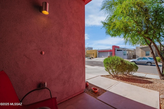 view of property exterior with stucco siding and a residential view