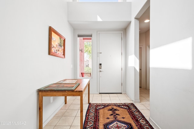 entryway featuring baseboards and light tile patterned floors