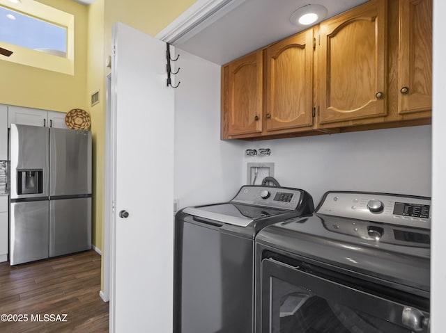 washroom featuring cabinet space, dark wood-style flooring, and washer and dryer