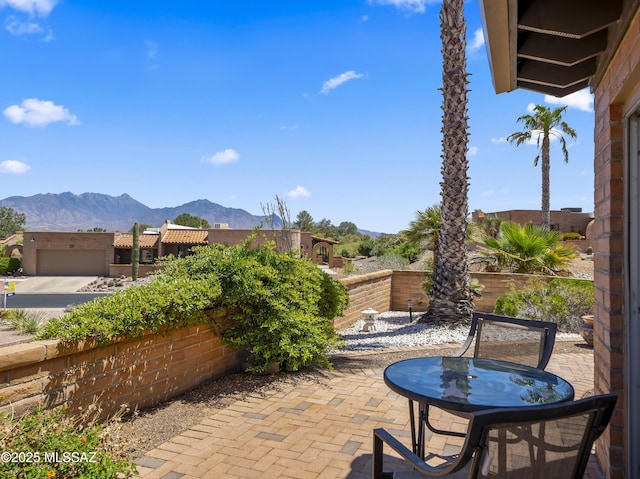 view of patio / terrace featuring a fenced backyard and a mountain view