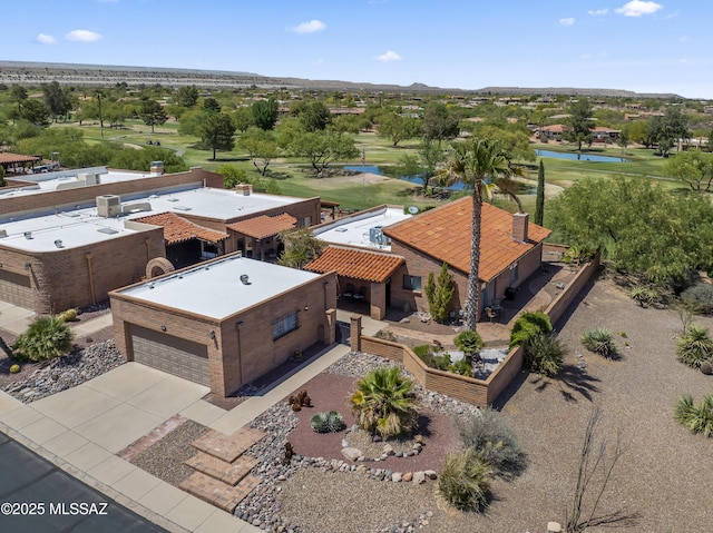 bird's eye view with a water view, view of golf course, and a residential view