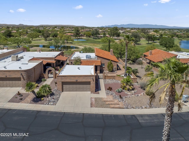 aerial view featuring a water and mountain view and view of golf course
