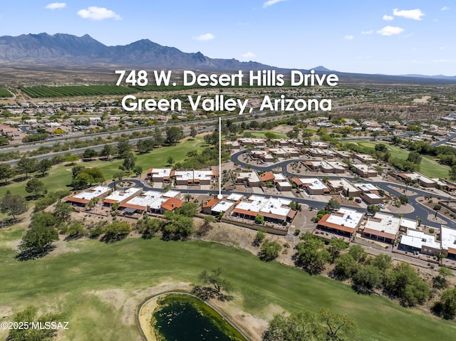 birds eye view of property with a mountain view, golf course view, and a residential view