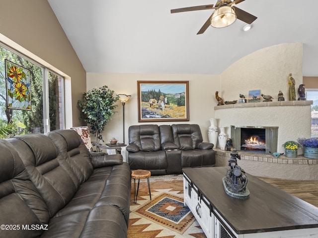 living area with a healthy amount of sunlight, ceiling fan, and lofted ceiling