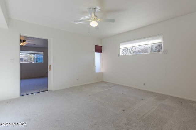 2102 E Florence Dr, Tucson, AZ 85719 - empty room with ceiling fan, plenty of natural light, carpet, and baseboards