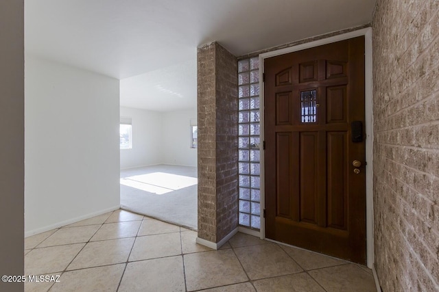 2102 E Florence Dr, Tucson, AZ 85719 - entryway featuring light tile patterned floors, baseboards, and light carpet
