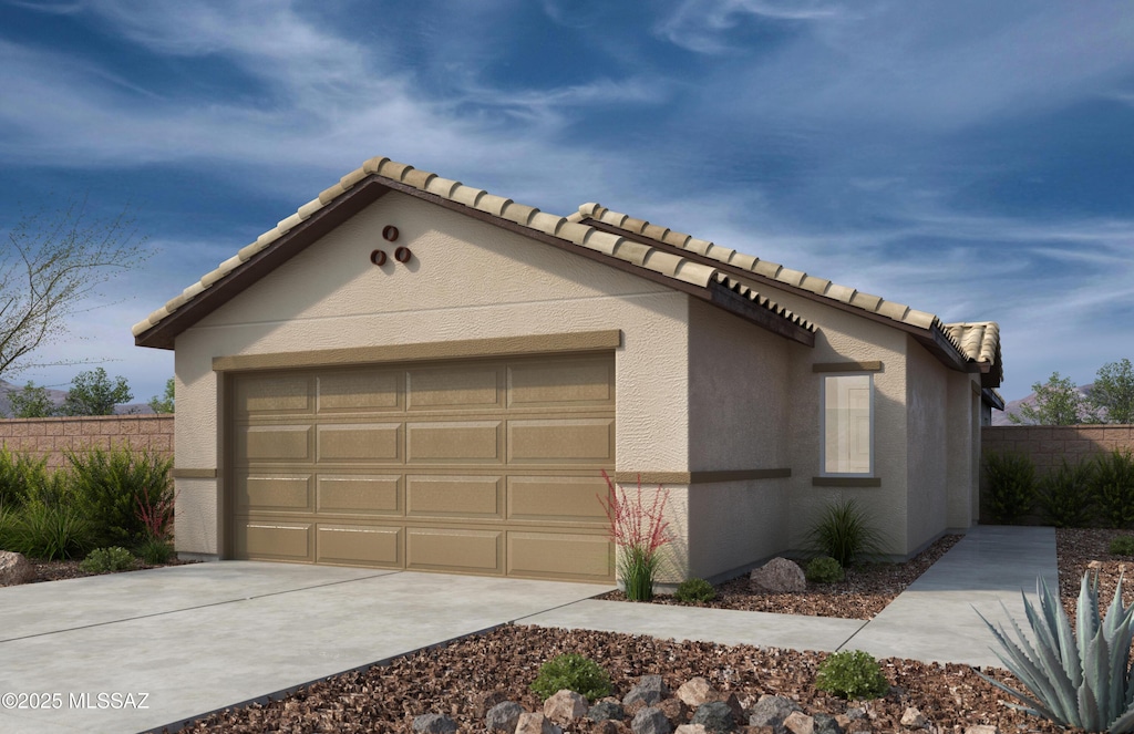 view of front facade with a garage, fence, stucco siding, driveway, and a tile roof
