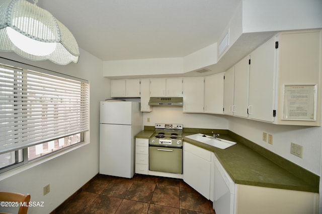 kitchen with freestanding refrigerator, dark countertops, range with electric stovetop, under cabinet range hood, and a sink