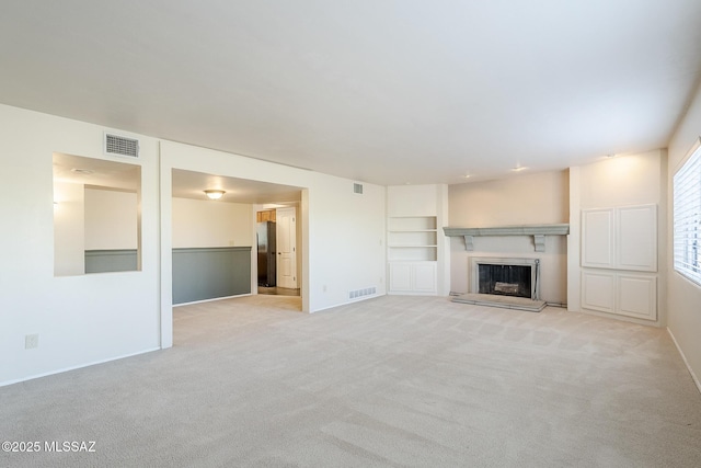 unfurnished living room featuring light colored carpet, baseboards, and visible vents