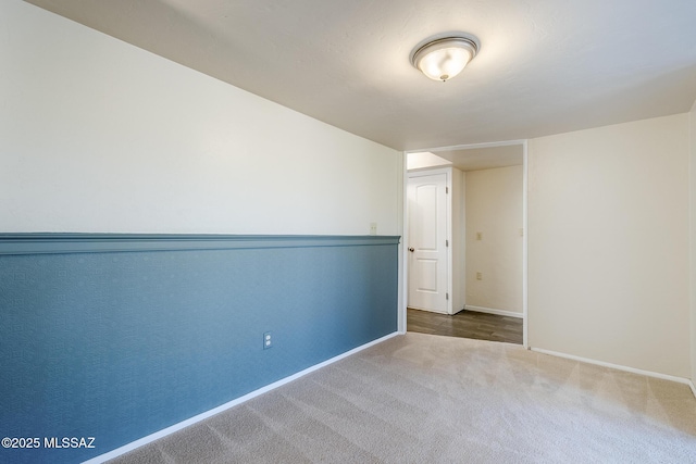 spare room with carpet flooring and baseboards