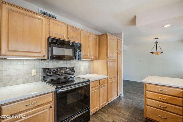 kitchen with light stone counters, backsplash, visible vents, dark wood-style floors, and black appliances