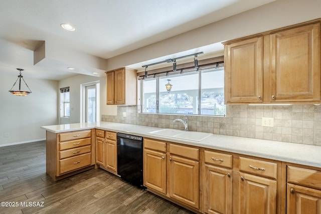 kitchen with a sink, dishwasher, dark wood finished floors, a peninsula, and backsplash