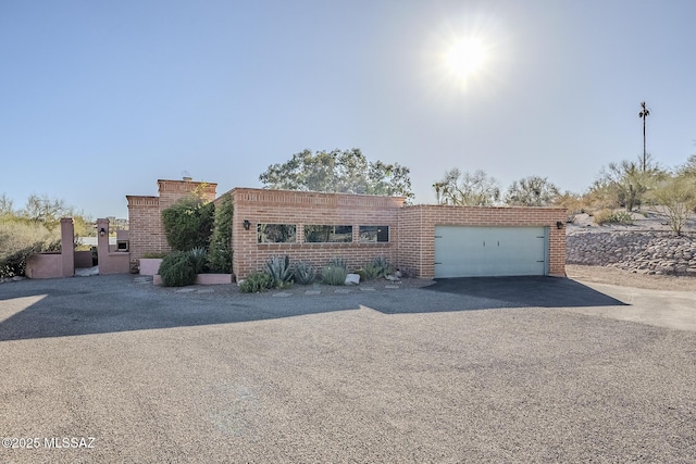 view of front of home featuring driveway and a garage