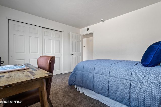 bedroom with baseboards, carpet, a closet, and visible vents