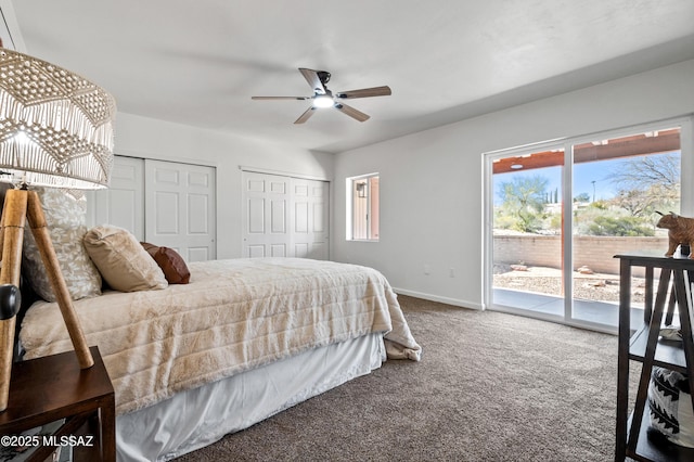 carpeted bedroom with baseboards, multiple windows, two closets, and access to exterior