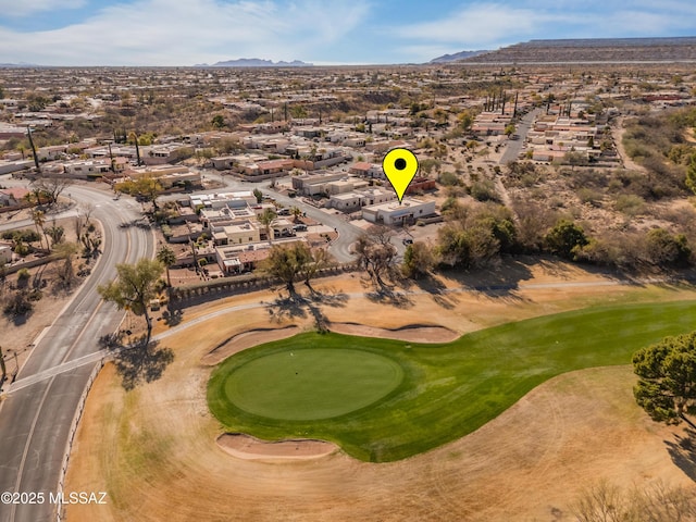 drone / aerial view featuring a residential view, a mountain view, and view of golf course