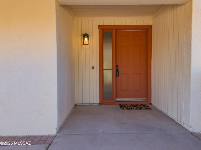 entrance to property featuring stucco siding