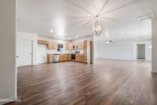 unfurnished living room featuring recessed lighting, dark wood-style flooring, a chandelier, and baseboards
