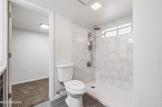 full bathroom with toilet and a tile shower