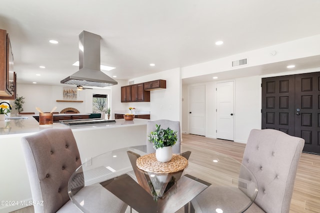 dining space featuring recessed lighting, visible vents, and light wood finished floors