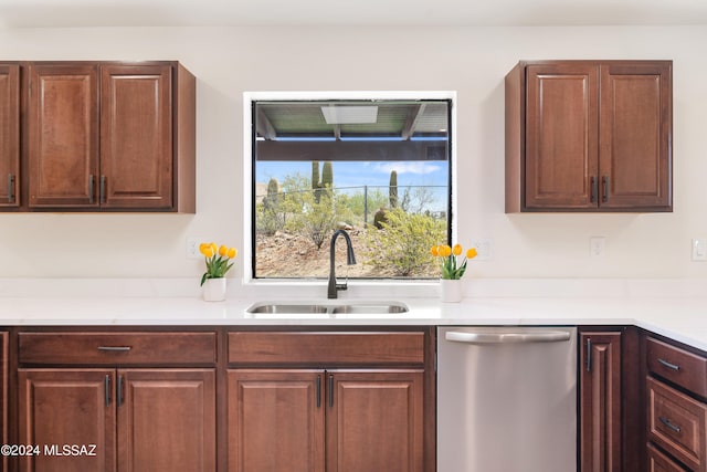 kitchen featuring a sink, dishwasher, and light countertops
