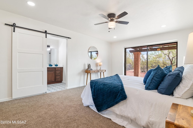 carpeted bedroom with recessed lighting, a barn door, ensuite bathroom, and access to exterior