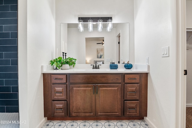 full bath with vanity, baseboards, and a ceiling fan