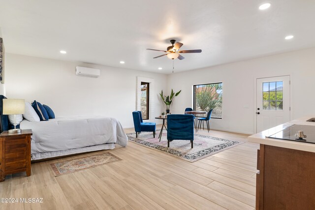 bedroom featuring light wood-style floors, baseboards, recessed lighting, and a wall mounted air conditioner