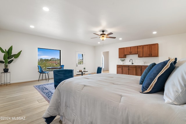 bedroom featuring a ceiling fan, a sink, baseboards, light wood finished floors, and recessed lighting